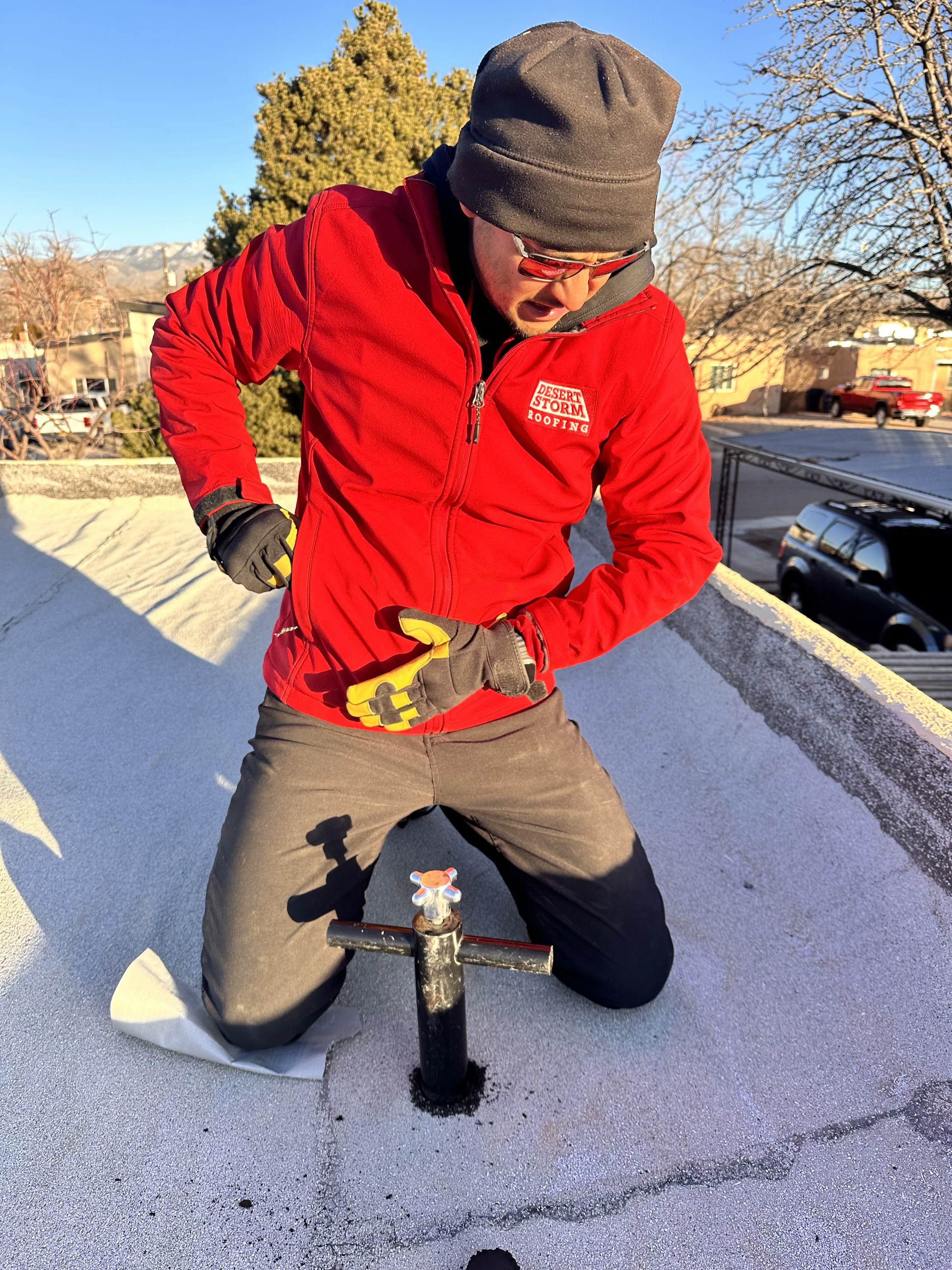 Desert Storm Roofing team member inspecting a roof penetration
