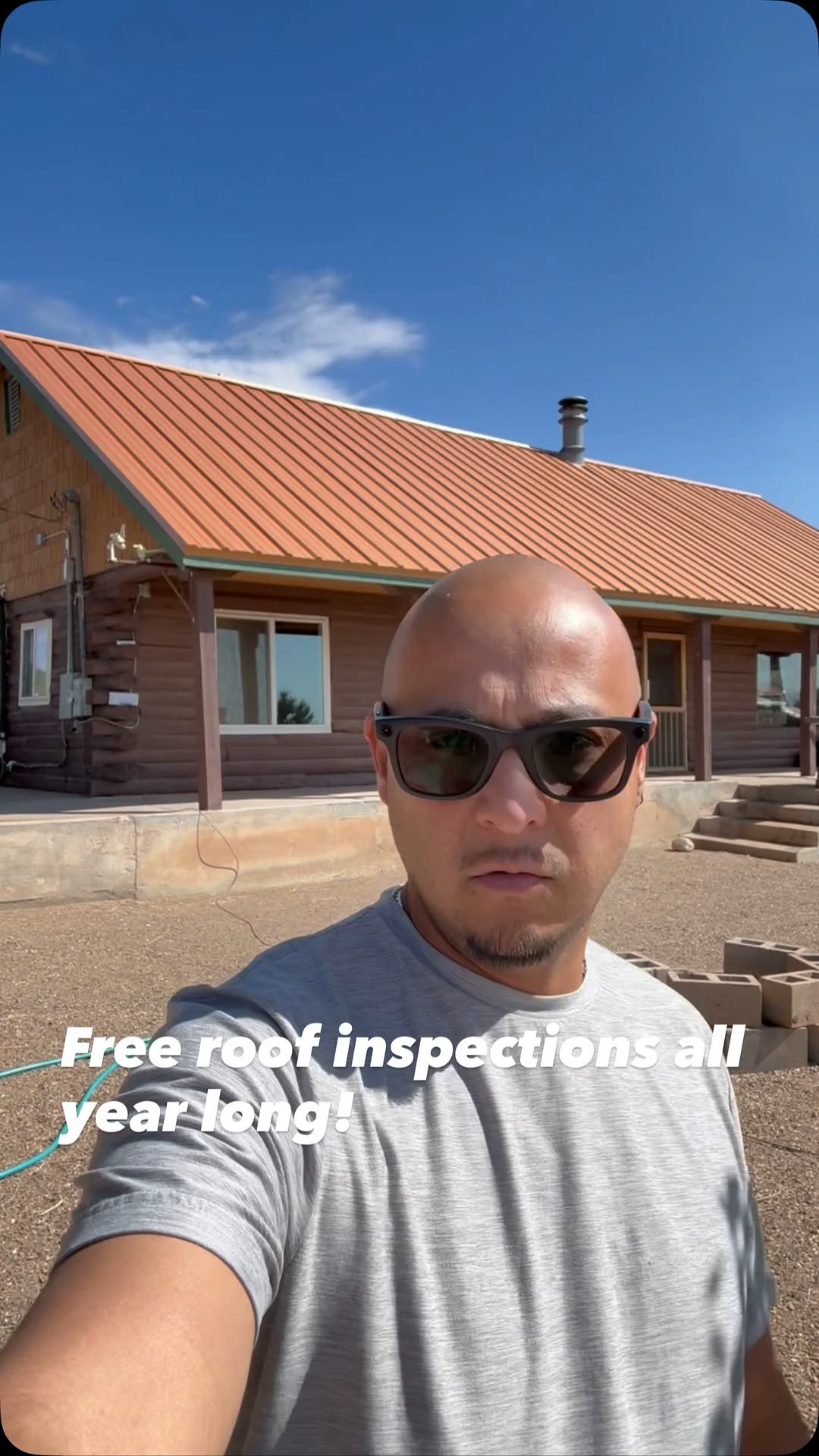 Desert Storm Roofing professional standing in front of a finished metal roof