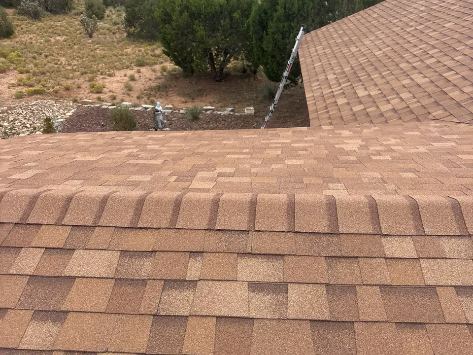Brown asphalt shingle roof overlooking a New Mexico landscape