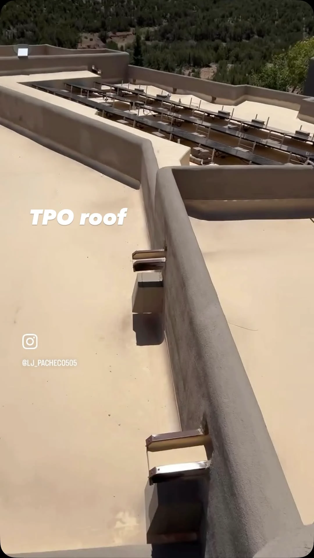 Light-colored TPO roof with rooftop equipment in New Mexico